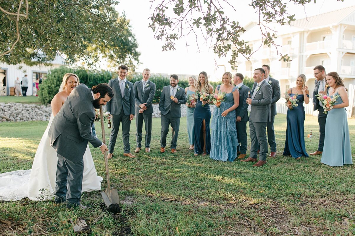 Digging up bourbon bottle at a North Carolina Wedding. Bourbon Bottle Wedding Tradition. 