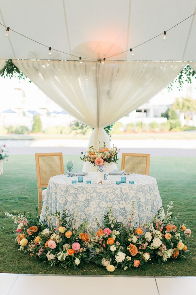 Blue and white sweetheart table with wildflower spring florals 