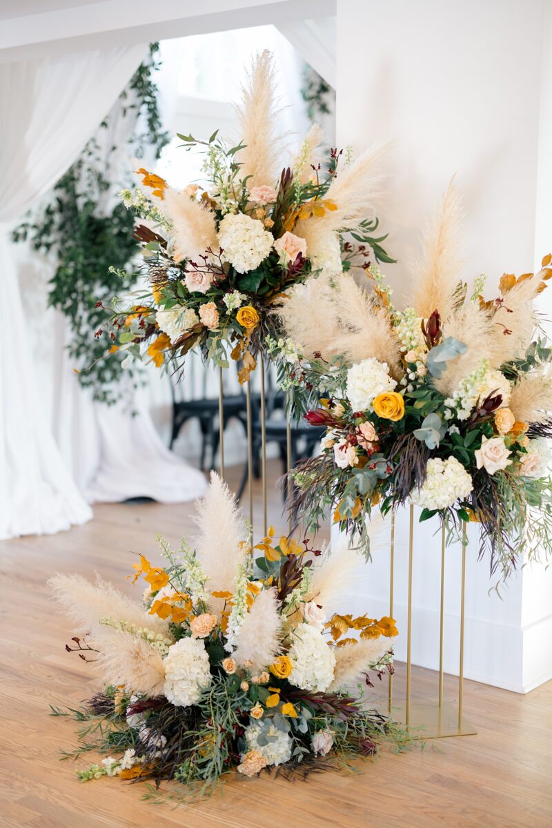 Fall orange and yellow florals for a wedding at Kindred Wedding and Events in Carolina Beach, NC