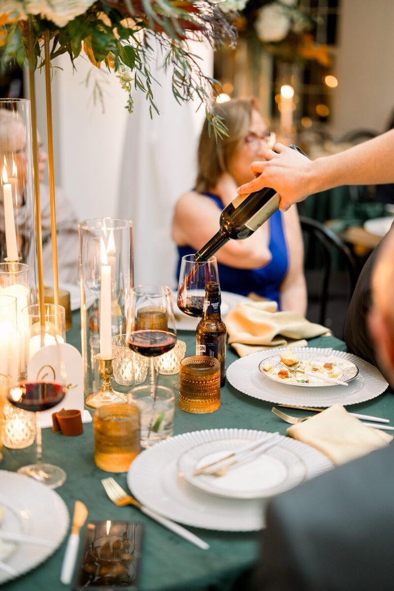 Table side wine service at fall wedding reception at Kindred Wedding and Events in Carolina Beach, NC. Planned by Brittanie Raquel Events. 