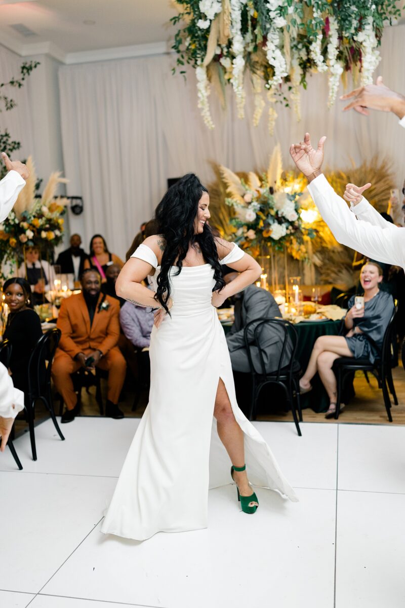 A bride dancing with a flash mob group at her wedding ceremony. A surprise guest experience planned by Brittanie Raquel Events. 