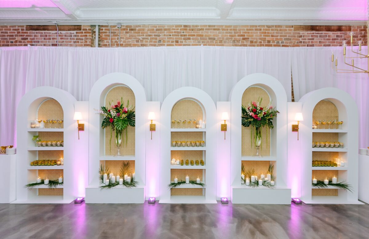 Draping and bookshelf rentals used to display food at wedding reception at The Elia