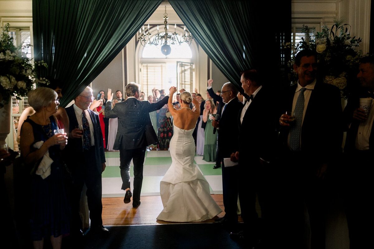 Bride and groom entering wedding reception at Cape Fear Club in downtown Wilmington NC